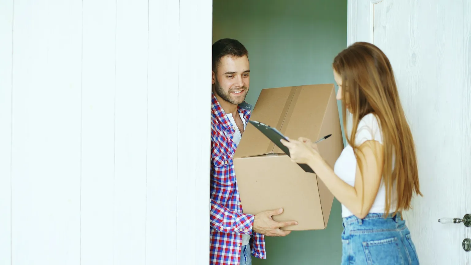 A resident signing for a plain unmarked package handed over at a residential front door