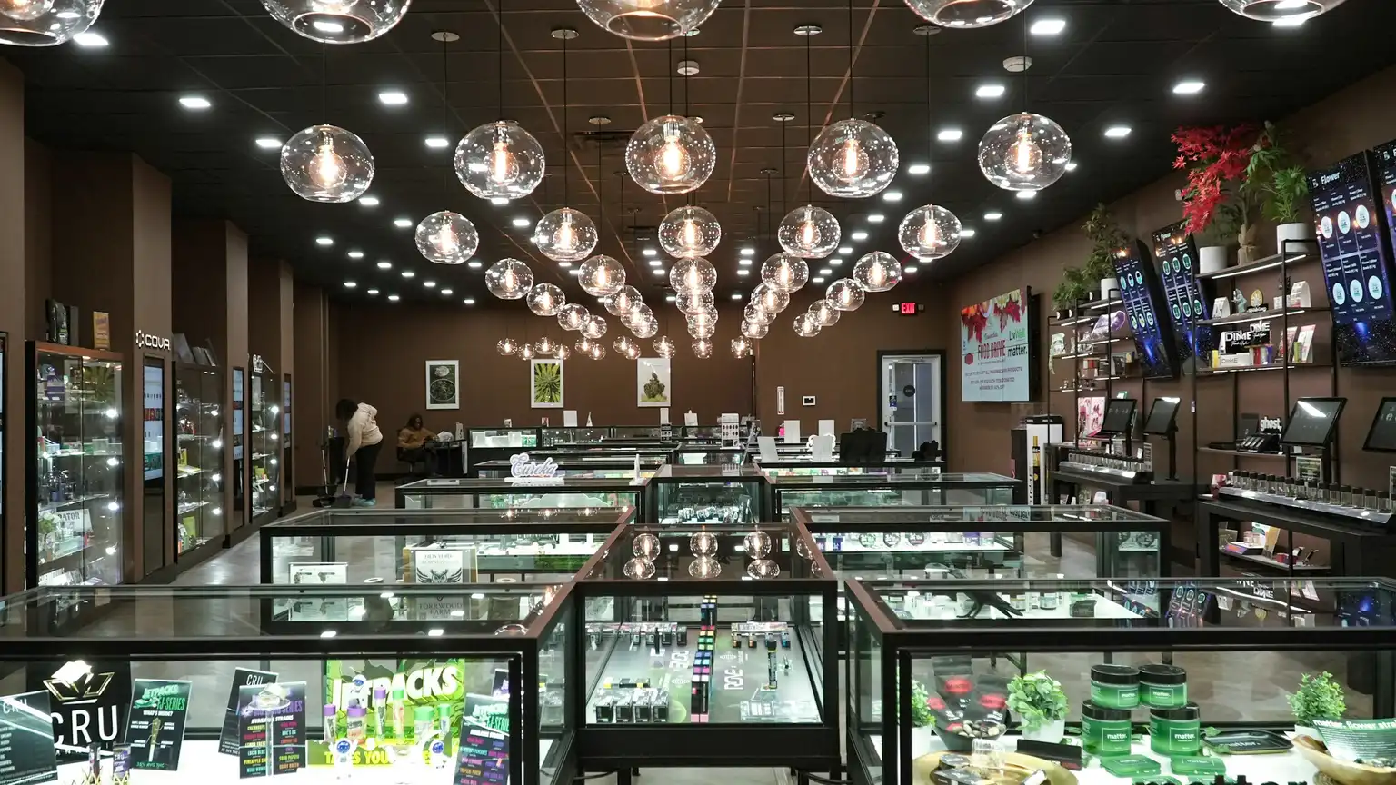 The interior of a licensed cannabis dispensary lined with lit glass display cases